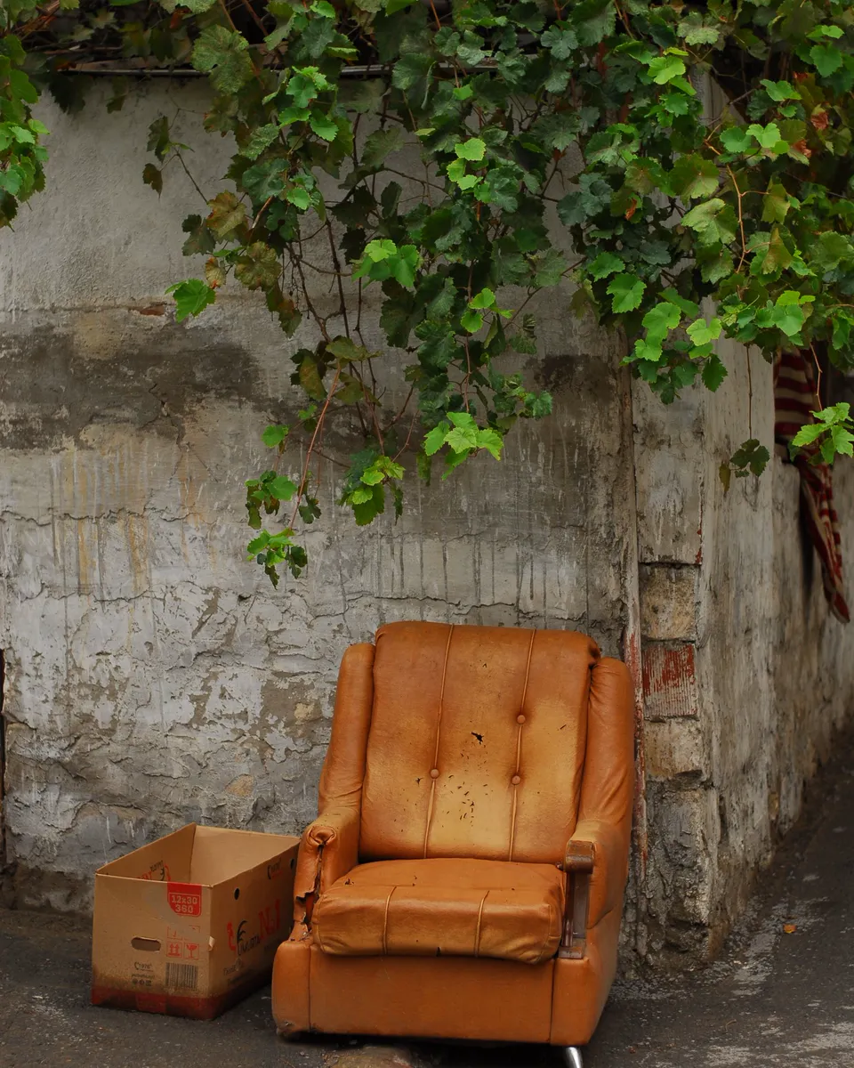 An armchair left on the sidewalk
