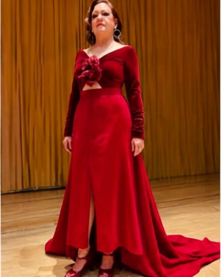 Yolanda on stage wearing the finished red velvet gown