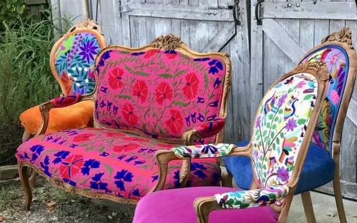 A settee and chairs reupholstered in embroidered fabric