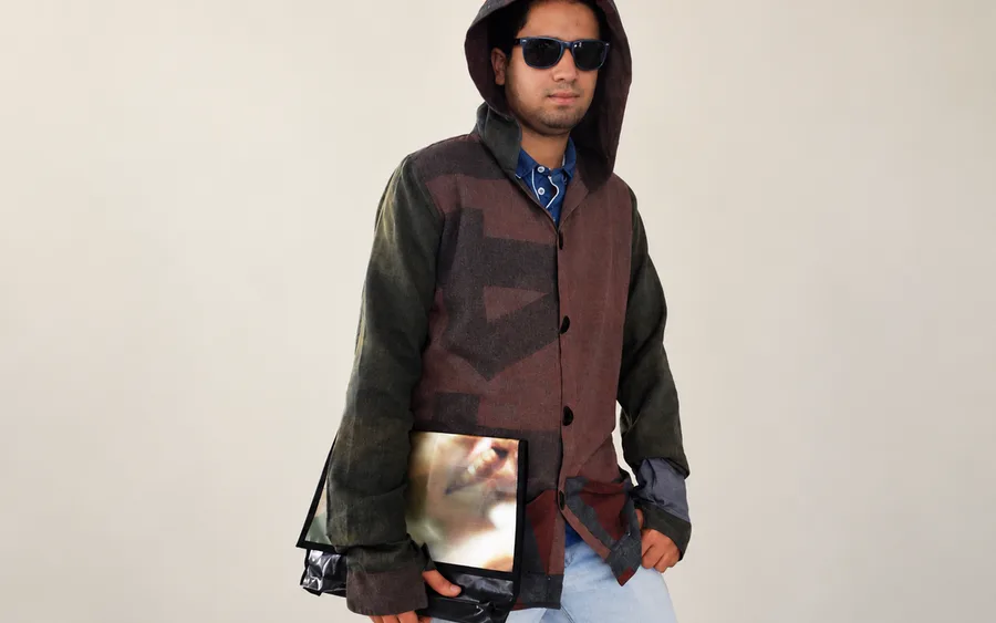 Rodrigo wearing a hooded jacket made from street signage