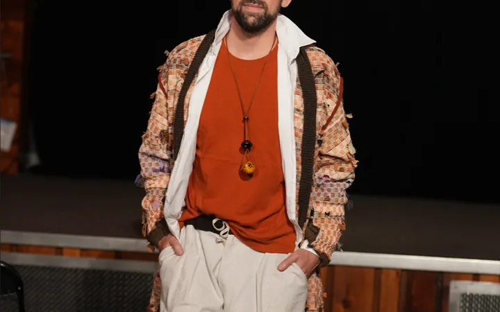 A model on the runway wearing an upcycled patchwork jacket